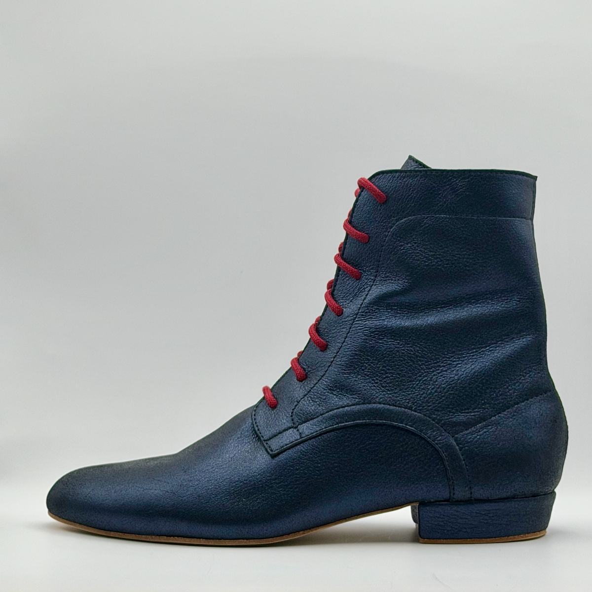 Opposite side profile of the Mono Bleu Marine tango boot showing the full shaft height, the curved heel overlay, and the navy leather-covered heel