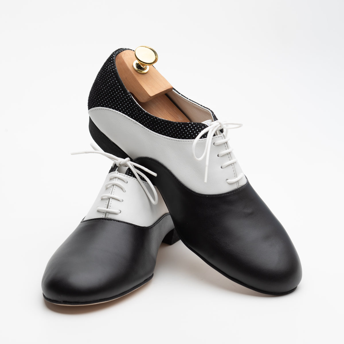Pair of Mono El Smoking tango oxfords at an angle, one resting on the other, showing the black-and-white contrast from toe to heel