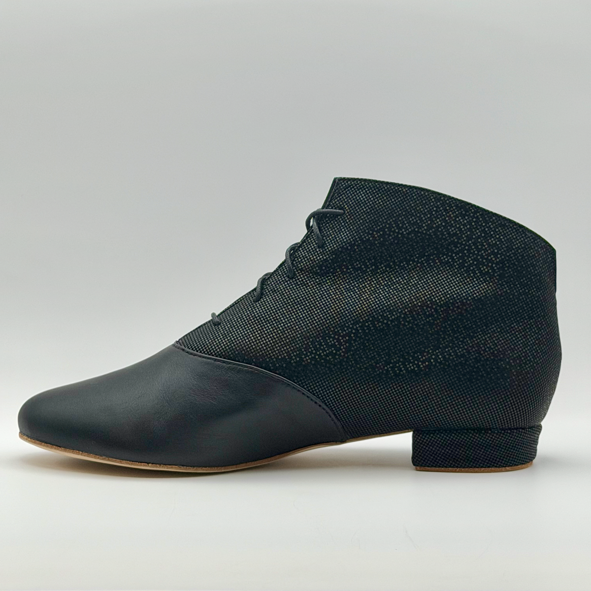 Opposite side profile of the Mono Fumée Bottine tango bootie, showing where the black leather toe meets the smoky micro-dot upper and the textured low Cuban heel