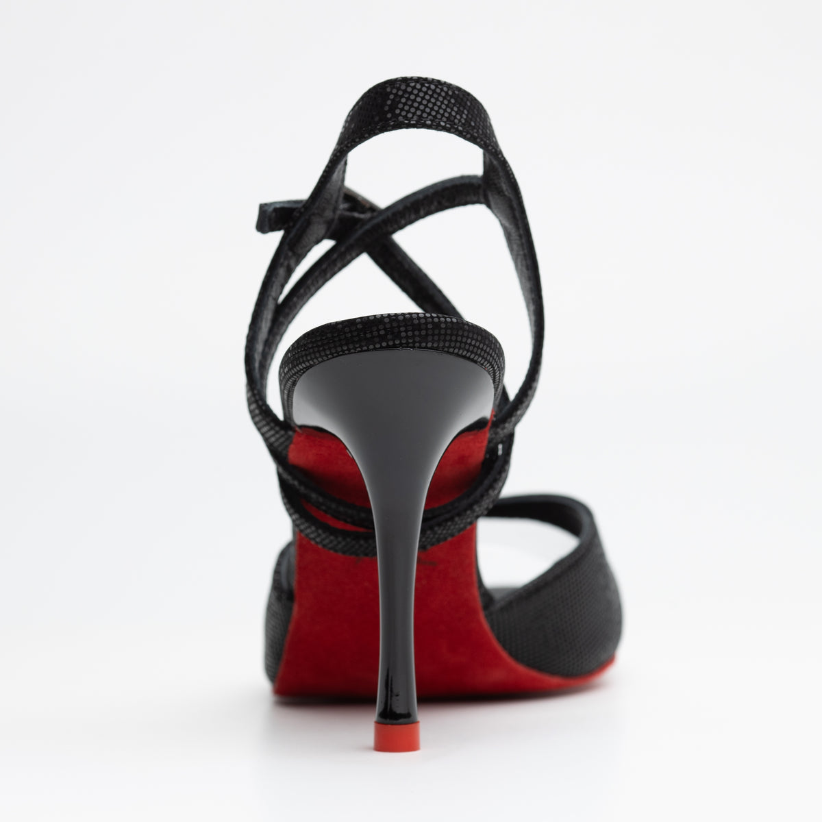 Rear view of Mono La Sombra women's tango sandal showing the crossed ankle straps, red sole, and slender stiletto heel.