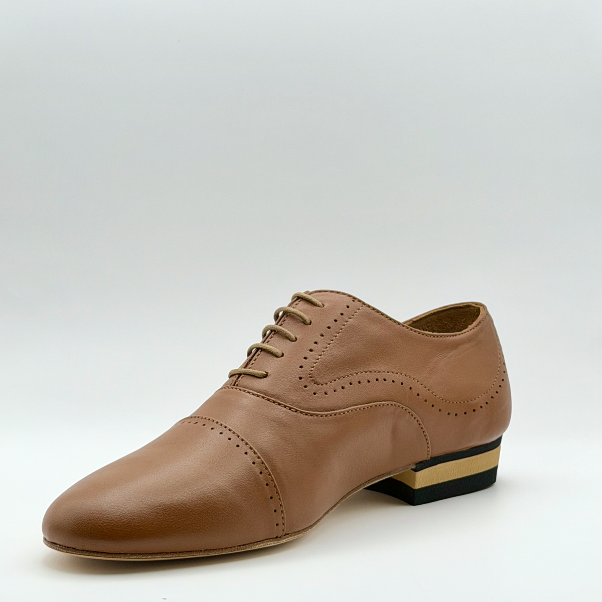 Front inner angle of the Tabacco men's tango oxford in brown leather with brogue detailing along the side and a striped heel