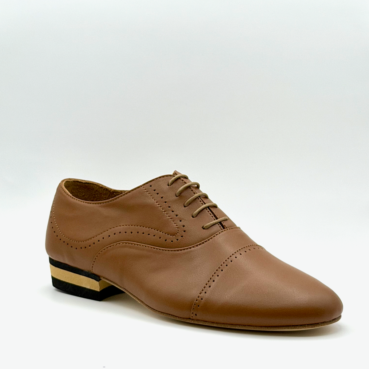 Three-quarter front view of the Tabacco tango oxford showing the almond toe, perforated cap toe seam, and tan waxed laces