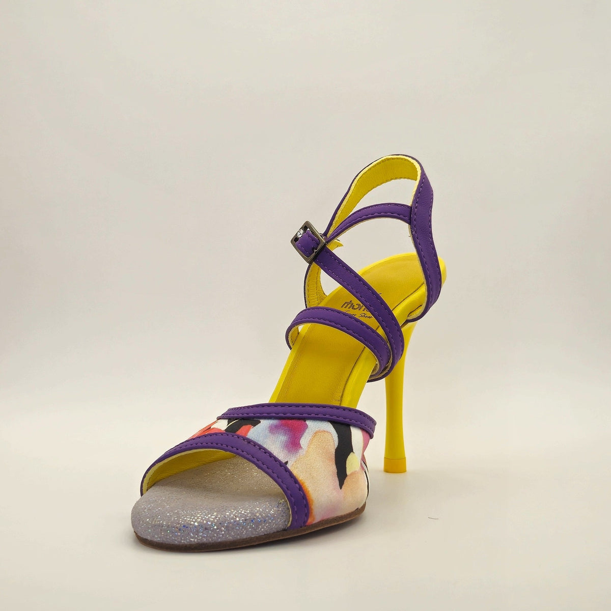 Three-quarter front view of Mono Tropical Orchid women's tango heel, showing silver glitter toe bed, insole stamp, and yellow heel.